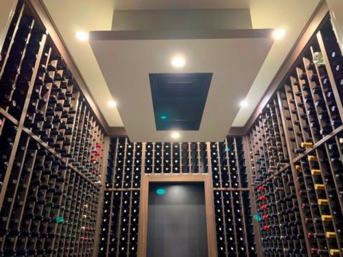 ceiling-mounted-whisperkool-cooling-unit-in-transitional-home-wine-cellar